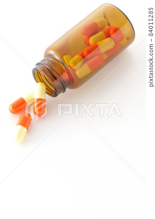 Photographed vials and capsules on a white background Photographed vials and capsules on a white background 84011285