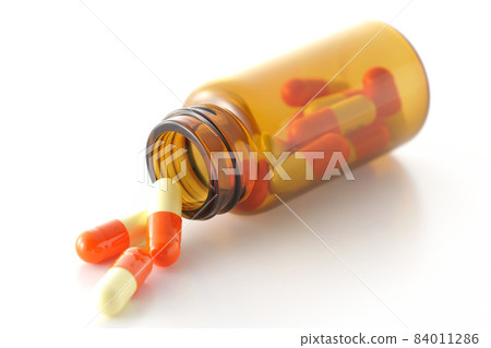 Photographed vials and capsules on a white background Photographed vials and capsules on a white background 84011286