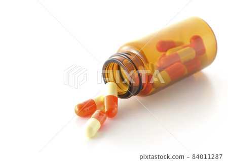 Photographed vials and capsules on a white background Photographed vials and capsules on a white background 84011287
