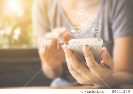 Woman hand using mobile smartphone with icon social media 84011299
