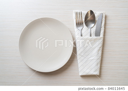 empty plate or dish with knife, fork and spoon 84011645