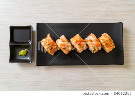 grilled salmon sushi roll with sauce 84012295
