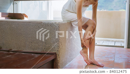 woman massages injury ankle woman massages injury ankle 84012475