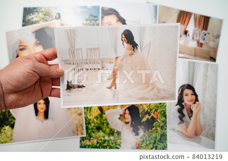 printed on paper photos of a beautiful brunette bride.  84013219