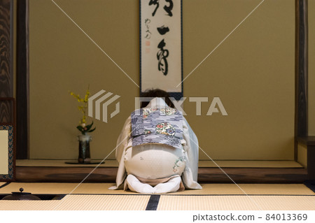 Japanese tea ceremony master during ceremonial preparation and presentation of powdered green tea matcha Japanese tea ceremony master during ceremonial preparation and presentation of powdered green tea matcha 84013369
