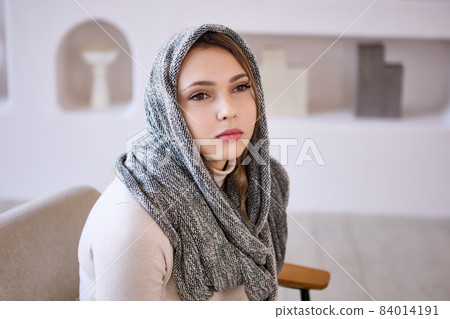 Headscarf, scarf or hijab on head of European woman. Headscarf, scarf or hijab on head of European woman. 84014191