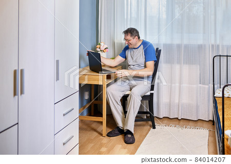 Working from home or telecommuting for mature man with laptop. Working from home or telecommuting for mature man with laptop. 84014207