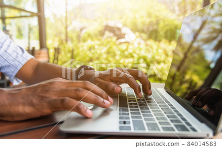 businessman sitting on desk work from home using laptop computer businessman sitting on desk work from home using laptop computer 84014583