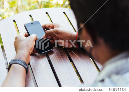 black businessman person holding a modern digital smart phone blank screen black businessman person holding a modern digital smart phone blank screen 84014584