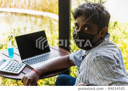 black man person sitting working with laptop computer black man person sitting working with laptop computer 84014585