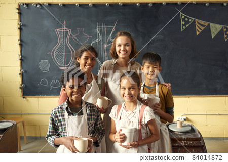 Group of intercultural schoolchildren and their handcraft teacher 84014872