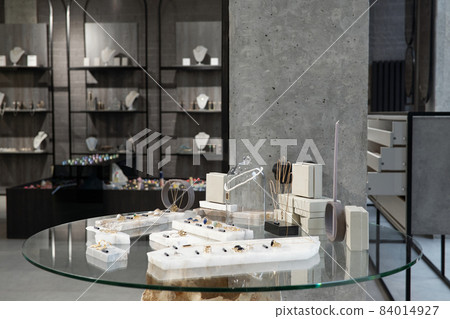 Table with assortment of jewelry items in luxurious boutique 84014927
