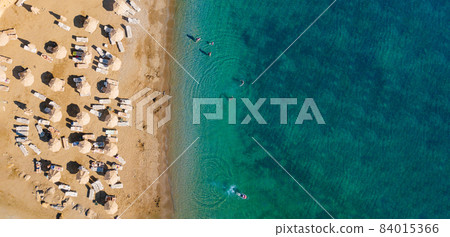 over beach of hotel. umbrellas and sunbeds on coast of sea. over beach of hotel. umbrellas and sunbeds on coast of sea. 84015366