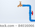 Brass faucet and blue PVC water pipe on white background. Closeup and copy space for text or article on the left. The concept of plumber maintenance work. 84016066