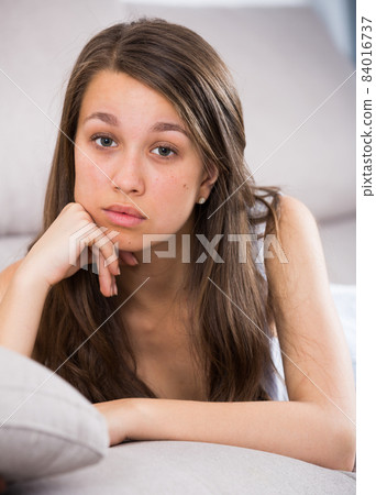 Woman is lying stressed and lonely on sofa Woman is lying stressed and lonely on sofa 84016737