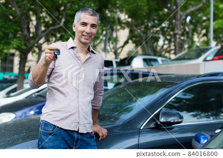 Portrait of man who is standing near his car 84016800