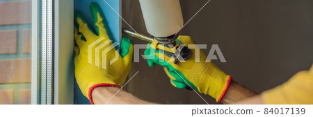 Builder or handyman is engaged in the repair or installation of windows BANNER, LONG FORMAT Builder or handyman is engaged in the repair or installation of windows BANNER, LONG FORMAT 84017139
