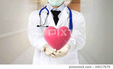 doctor puts heart in front doctor puts heart in front 84017676