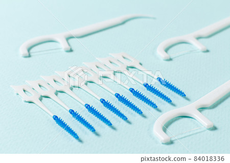 Close-up interdental brushes on the blue background 84018336