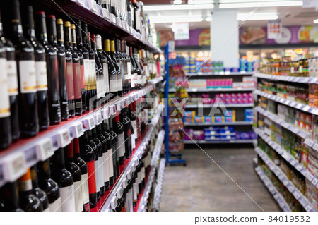 Shelves with wine at beverage section of supermarket.  84019532