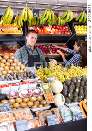 man vendor selling fresh fruits and vegetables man vendor selling fresh fruits and vegetables 84019628