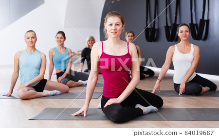 Females practicing yoga in studio Females practicing yoga in studio 84019687