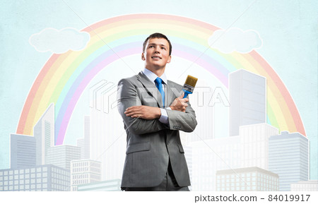 Creative businessman painter holding paintbrush Creative businessman painter holding paintbrush 84019917