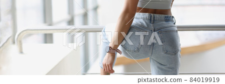 Fitness bracelet putting on hand of young woman back view Fitness bracelet putting on hand of young woman back view 84019919