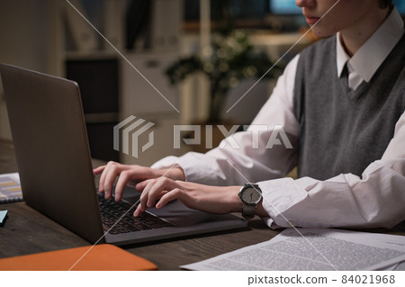 Close-up of businesswoman typing on laptop doing her online work at her workplace at office Close-up of businesswoman typing on laptop doing her online work at her workplace at office 84021968