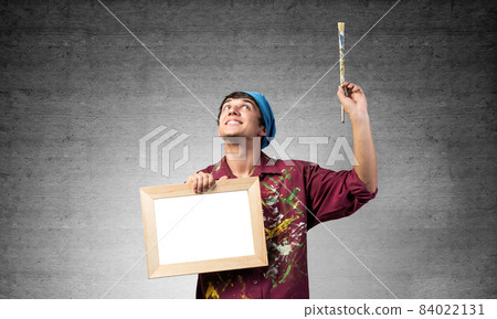 Young handsome painter artist holding paintbrush Young handsome painter artist holding paintbrush 84022131