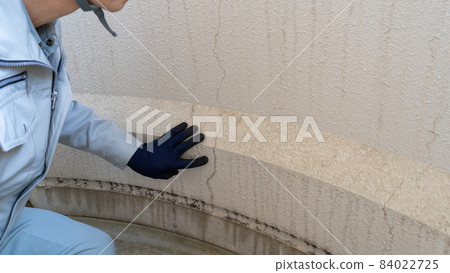 Workers inspecting deterioration and cracks on the outer wall Workers inspecting deterioration and cracks on the outer wall 84022725