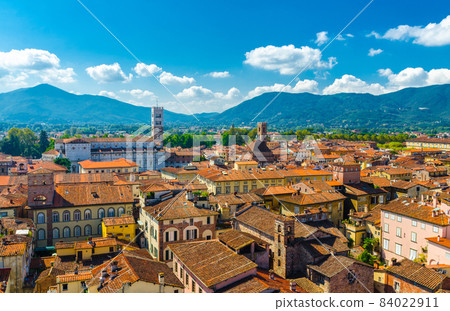 Aerial top panoramic view of historical centre medieval town Lucca with old buildings, typical orange terracotta tiled roofs Aerial top panoramic view of historical centre medieval town Lucca with old buildings, typical orange terracotta tiled roofs 84022911