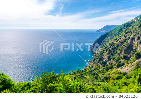 Aerial top panoramic view of green hills, rocks, cliffs and Gulf of Genoa, Ligurian Sea 84023126