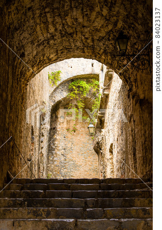 Stone walls, stairs and lamp indoor of ancient Castello Doria castle tower in Portovenere town 84023137