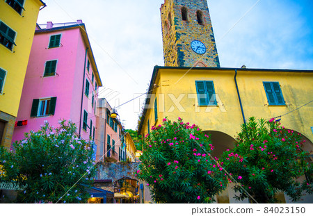 Catholic Church of San Giovanni Battista chiesa with clock tower, colorful buildings 84023150