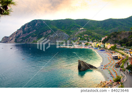 Top aerial view of green hills, rocks, harbor and beach of Monterosso town 84023646
