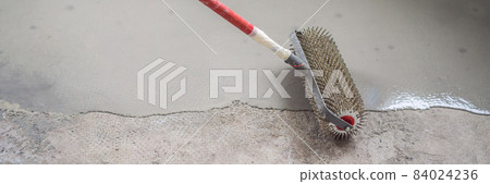 plasterer during floor covering works with self-levelling cement mortar, uses a needle roller BANNER, LONG FORMAT plasterer during floor covering works with self-levelling cement mortar, uses a needle roller BANNER, LONG FORMAT 84024236