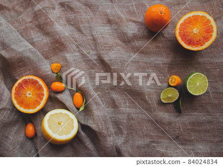 Orange yellow lemon green lime and spice herbs on brown rustic raw sackcloth fabric photo. A4 A5 international paper slide poster card frame element with free blank copy space for text Orange yellow lemon green lime and spice herbs on brown rustic raw sackcloth fabric photo. A4 A5 international paper slide poster card frame element with free blank copy space for text 84024834