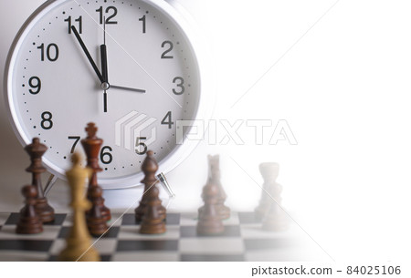 Clock and Chess pieces on a chessboard. as background. The concept of playing and winning a chess tournament Clock and Chess pieces on a chessboard. as background. The concept of playing and winning a chess tournament 84025106