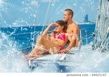 Couple enjoying sea trip along coast of Barcelona 84025147