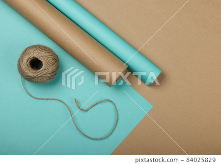 Packing Christmas gifts with blue and brown paper 84025829
