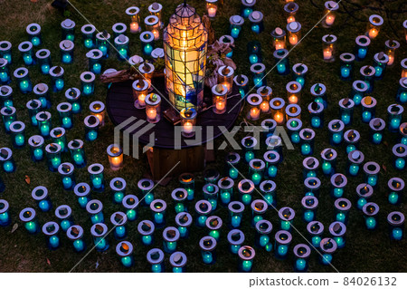 Fantastic candle monuments, green and orange candles, candle lights up 84026132