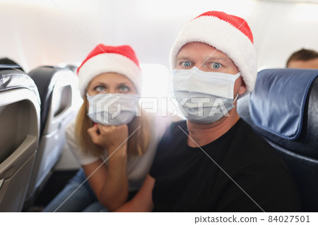 Couple tired of strong restrictions and need to wear face mask on board 84027501