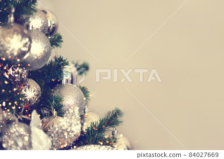 Silver Christmas balls on a fir branch. 84027669