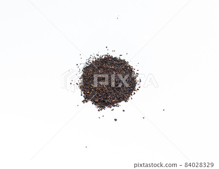Black tea on a white background. Tea leaves 84028329