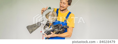 Carpenter with miter saw. Woodworking. Professional worker BANNER, LONG FORMAT Carpenter with miter saw. Woodworking. Professional worker BANNER, LONG FORMAT 84028479