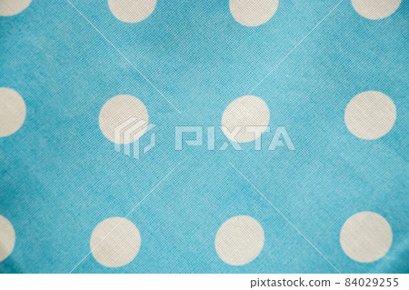 Blue cotton fabric with white polka dots closeup. Blue cotton fabric with white polka dots closeup. 84029255