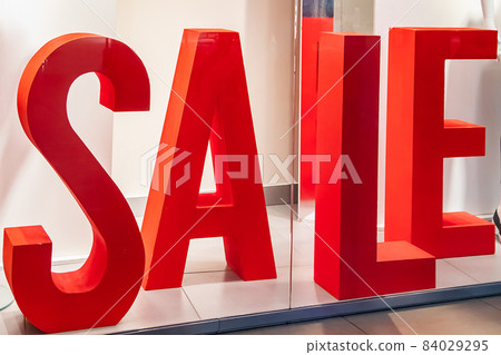 Big red banner for sale in a shopping center. The beginning of sales in the store. Big red banner for sale in a shopping center. The beginning of sales in the store. 84029295