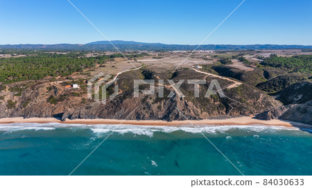 Aerial view of the Portuguese mountain coastline, Vicentina. Aljezur village, beach Vale dos Homens. Sagres 84030633