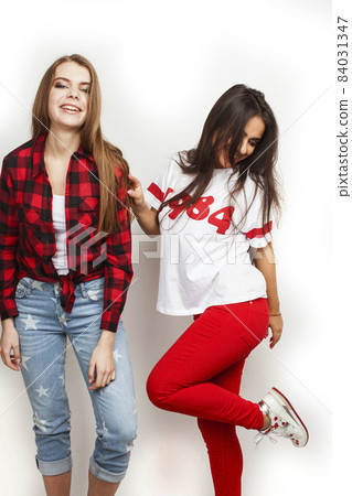 best friends teenage girls together having fun, posing emotional on white background, besties happy smiling, lifestyle people concept, blond and brunette multi nations 84031347